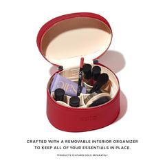 Saie mini vanity case shown held by handle illustrating easy carry and travel convenience