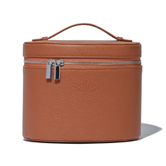 Saie Vanity Case front view showing caramel brown vegan leather and secure zip for travel