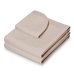 Saloniture fitted sheet on massage table demonstrating secure elastic fit benefit