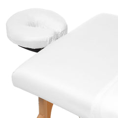 Saloniture flat sheet spread across massage table offering full coverage
