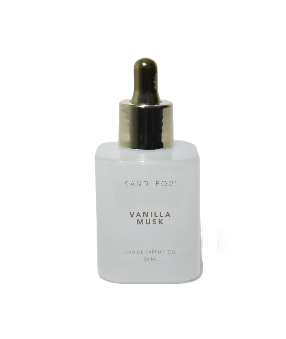 Sand + Fog dropper applying perfume oil to wrist for long-lasting fragrance
