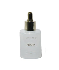 Sand + Fog dropper applying perfume oil to wrist for long-lasting fragrance