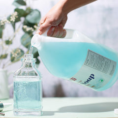 Sanit being poured into foaming dispenser for easy refill