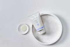 Sanitas texture closeup revealing creamy scrub and ultra-fine silica crystals for gentle exfoliation
