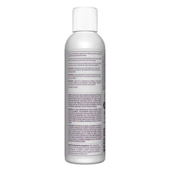 Satin developer in stylist hands applying color demonstrates control and shiny finish benefit
