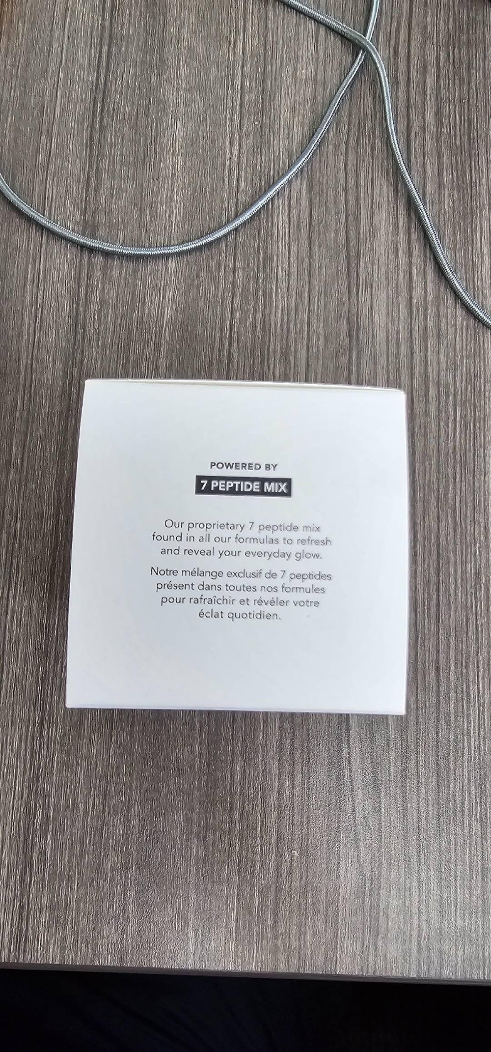 Open cap and label detail highlighting product information and ingredient callouts