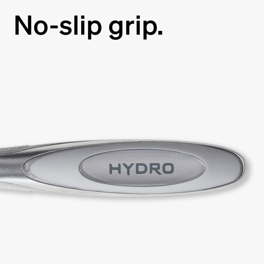 Schick Hydro razor held in wet hand demonstrating ergonomic grip and wet use benefit