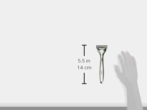 Schick Quattro Titanium handle held in hand to show actual size and scale