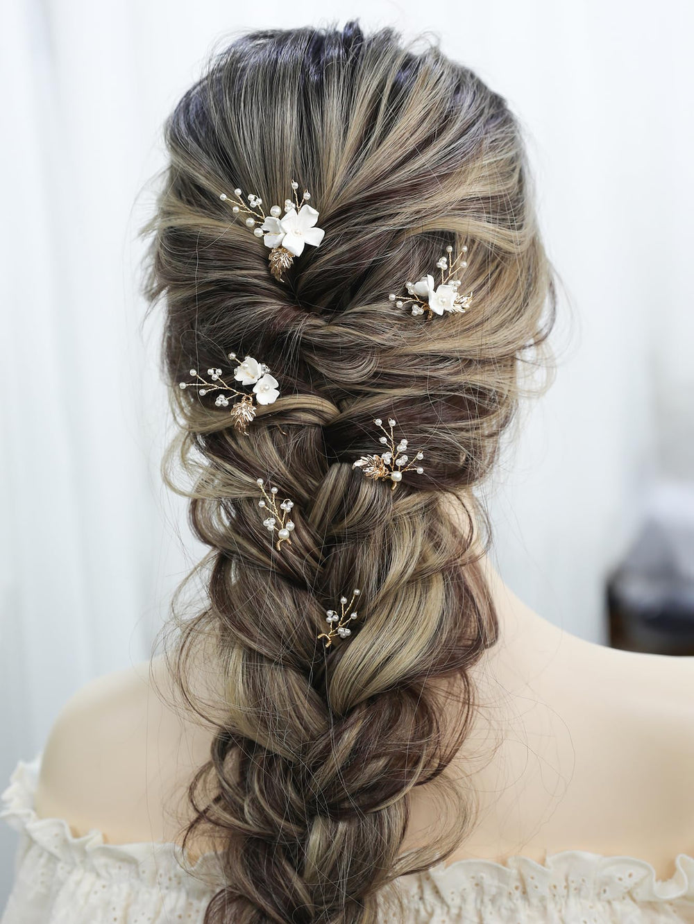 SELFCLOUD pinned into bridal updo adding elegant floral accent