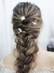 SELFCLOUD pinned into bridal updo adding elegant floral accent