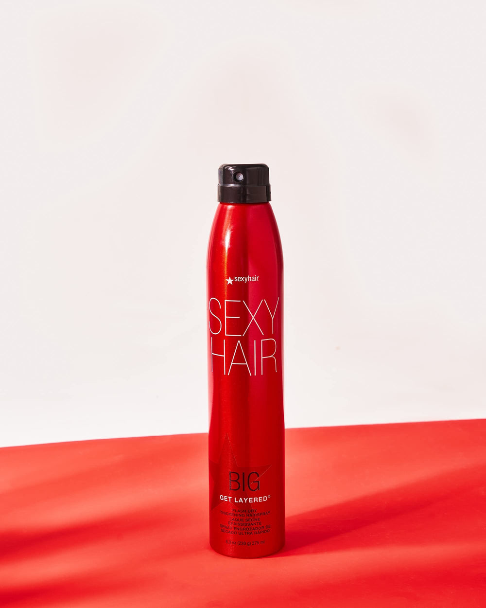 SexyHair can beside a hand showing 8 oz scale for travel and storage