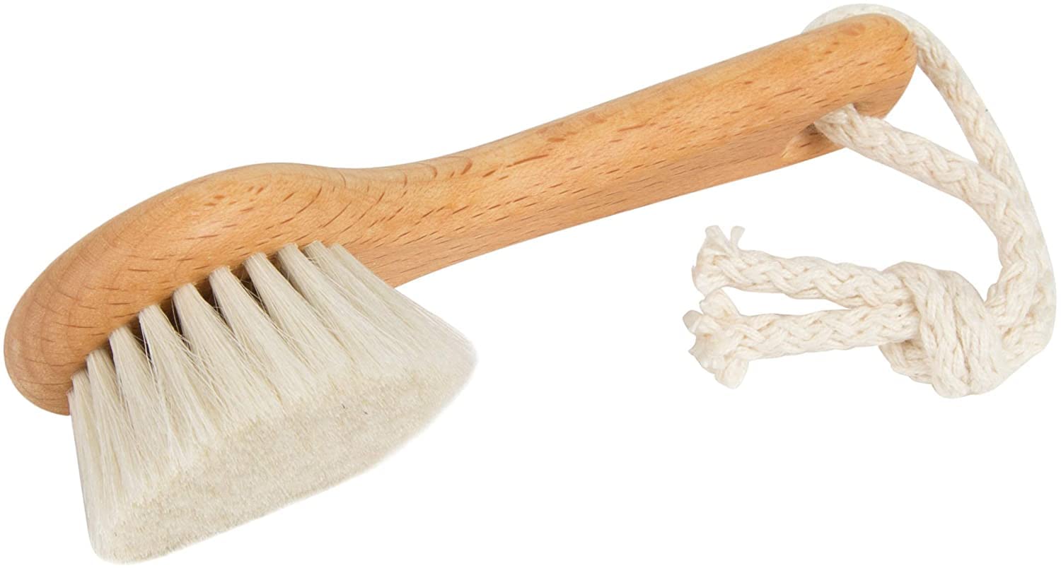 SHASH brush next to hand for scale, clarifies compact travel-ready size