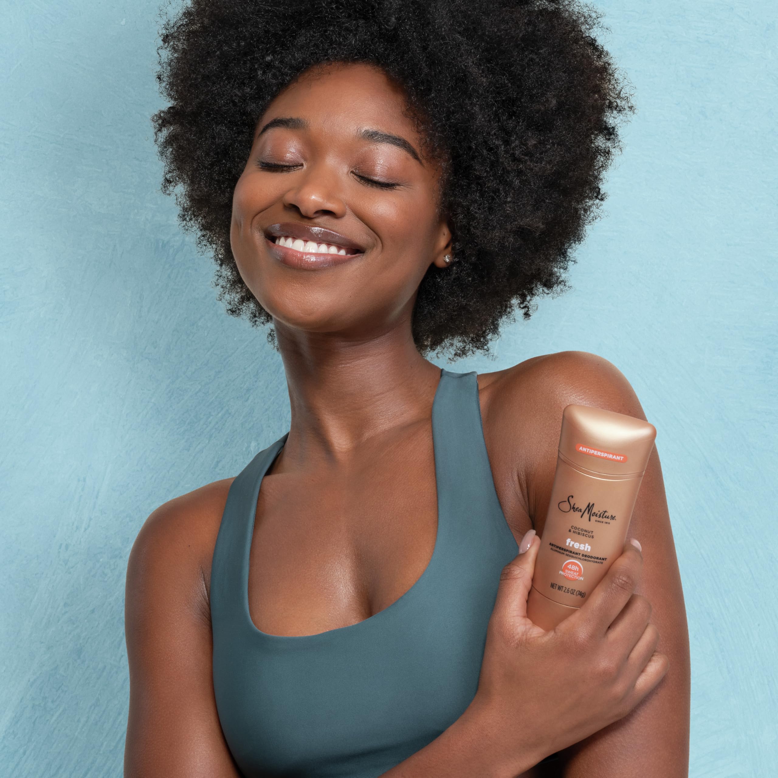 SheaMoisture size comparison in hand showing portable 2.6 oz convenience