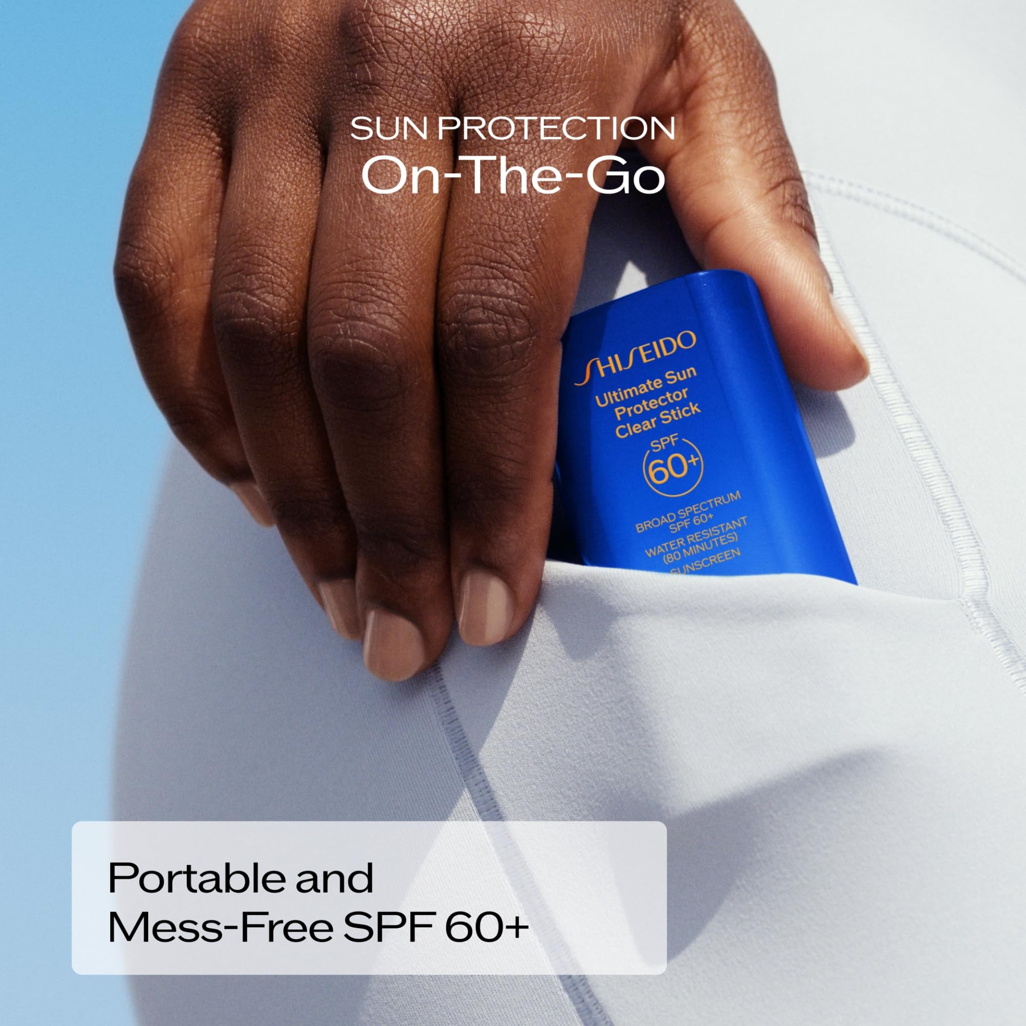 Shiseido clear stick size next to hand showing portable travel-friendly scale