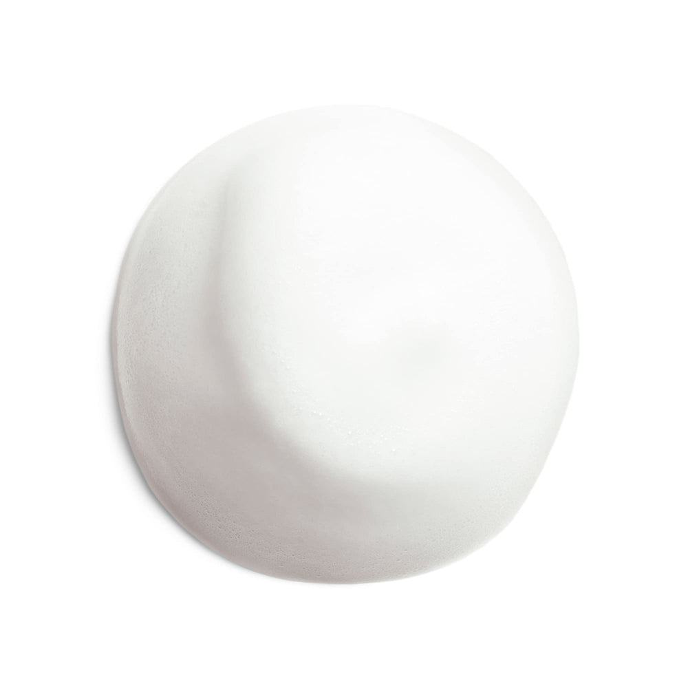 Shiseido Microfoam held in hand to show 180 mL scale and travel-friendly size benefit