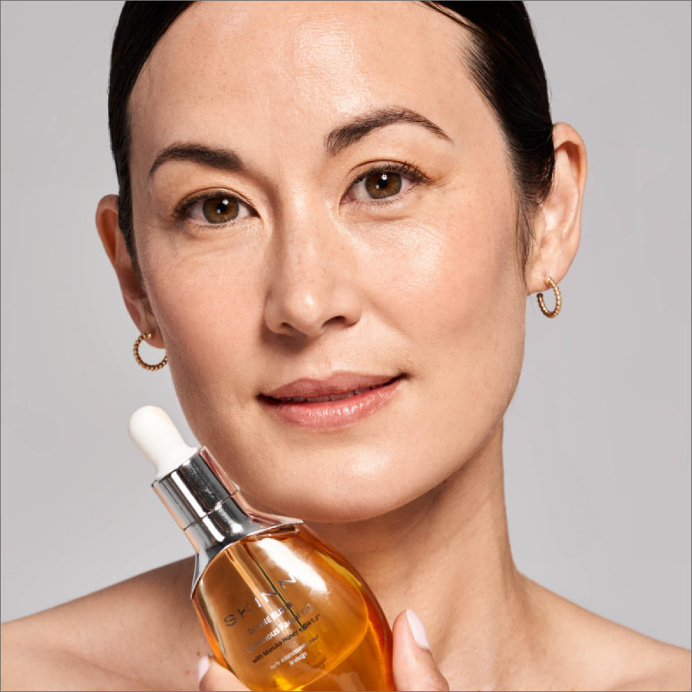 SKINN face oil scale with fruit to show size and natural ingredient inspiration