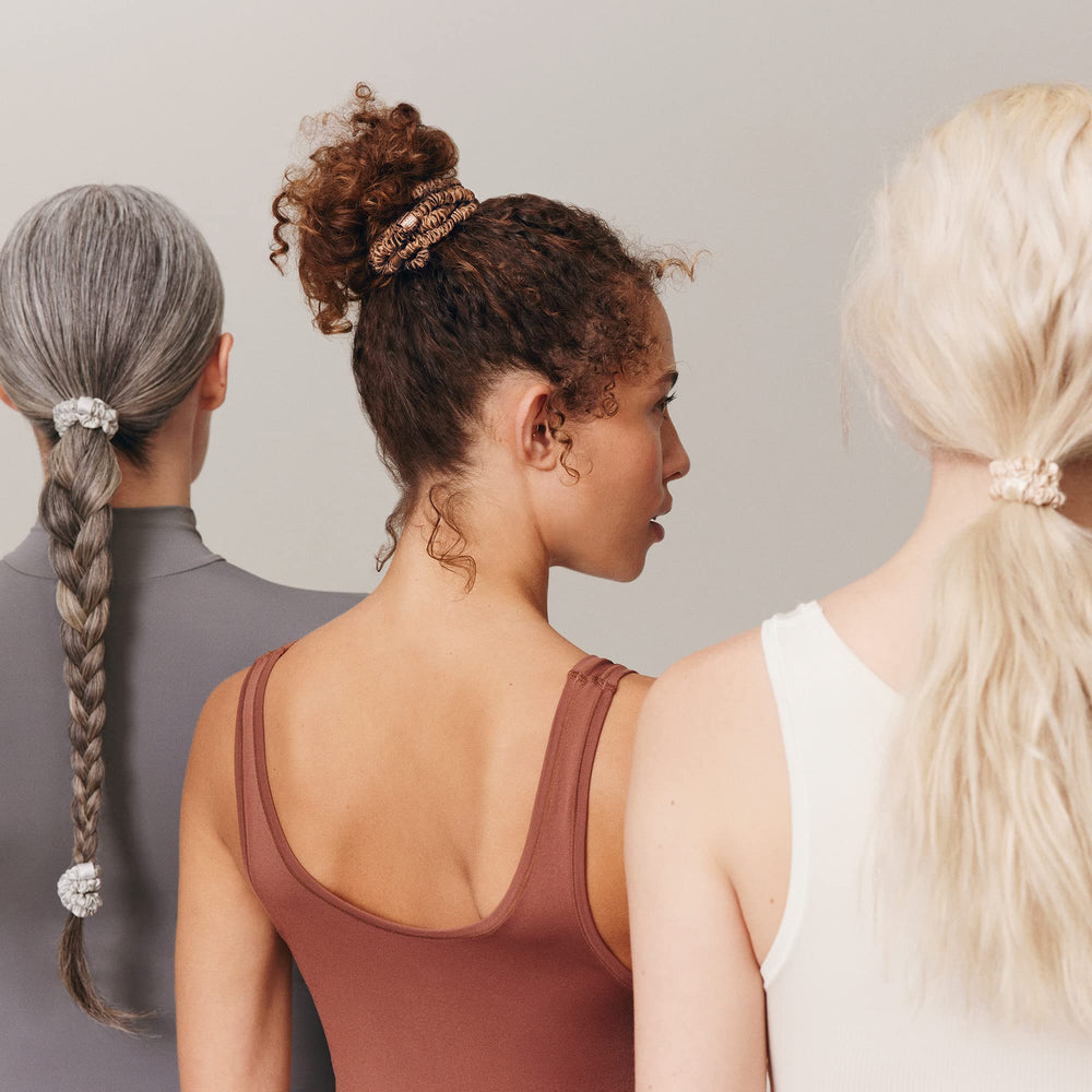 Lifestyle vanity scene with SLIP scrunchies near mirror, polished everyday accessory