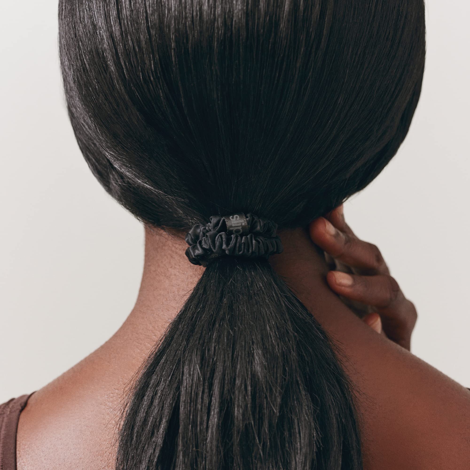SLIP scrunchie worn in a ponytail outdoors, comfortable all-day hold without pulling
