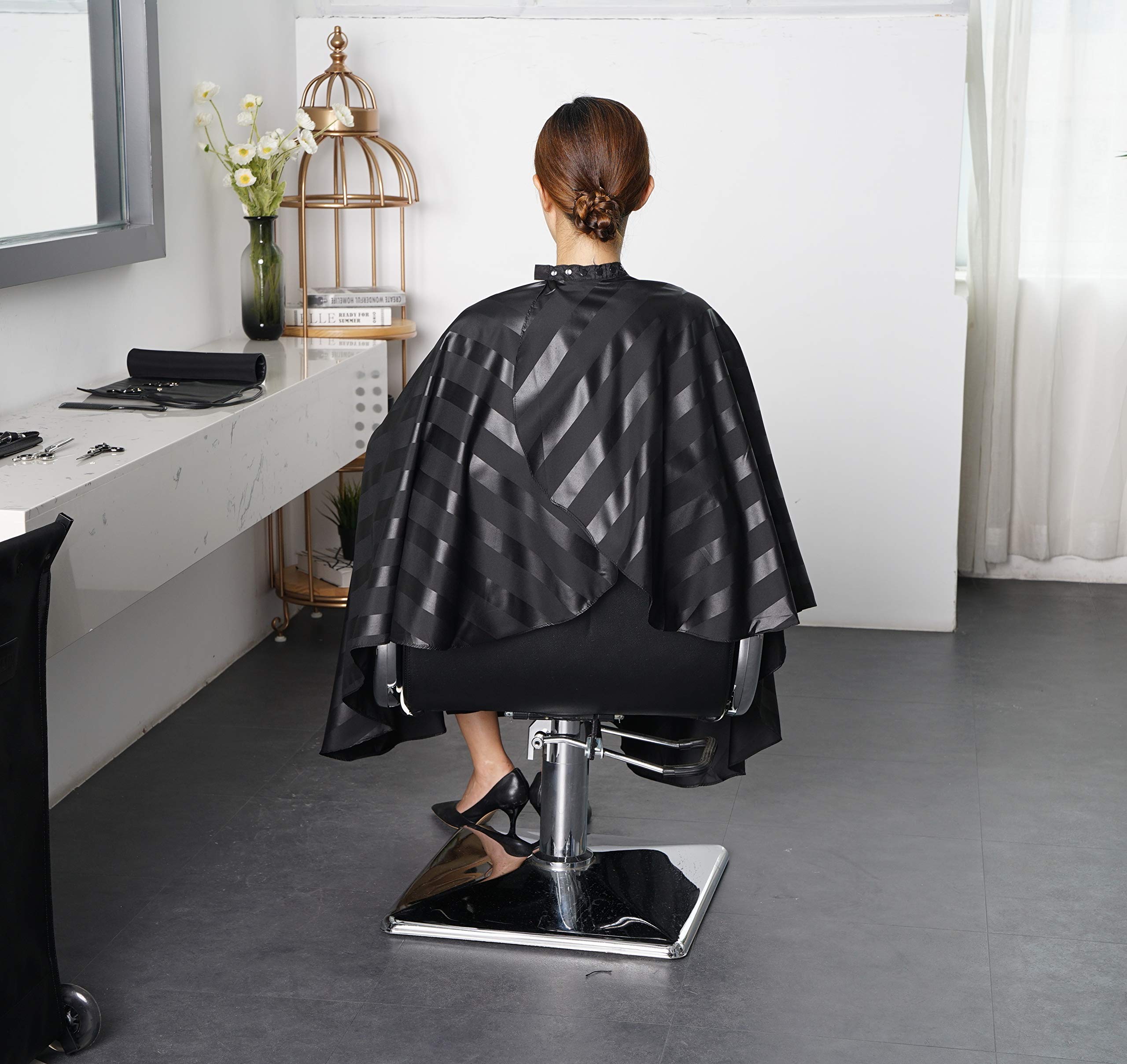 SMARTHAIR cape in use on a client in a barber chair for clean service