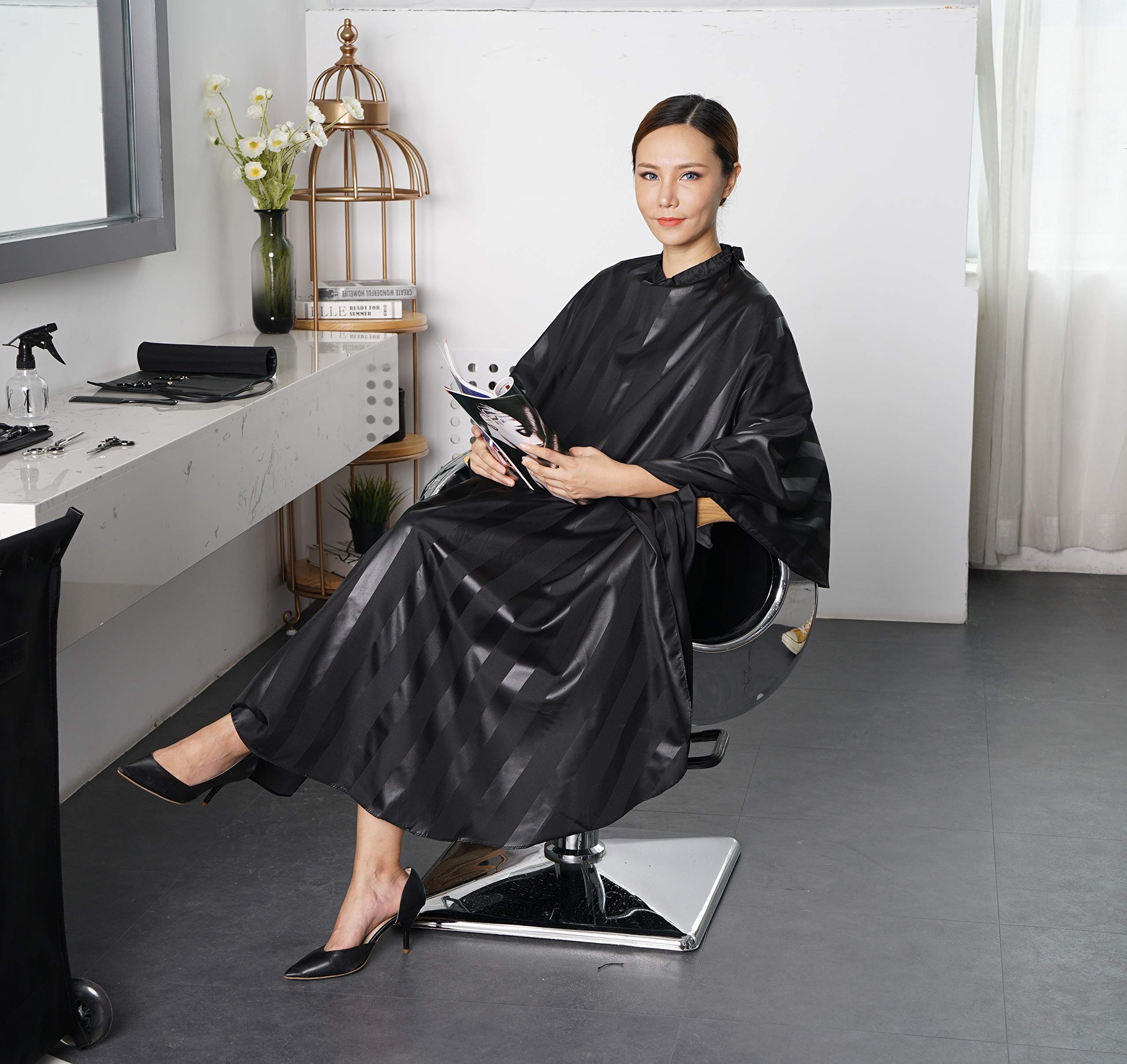 SMARTHAIR cape next to ruler showing 54x62 inch size for full coverage