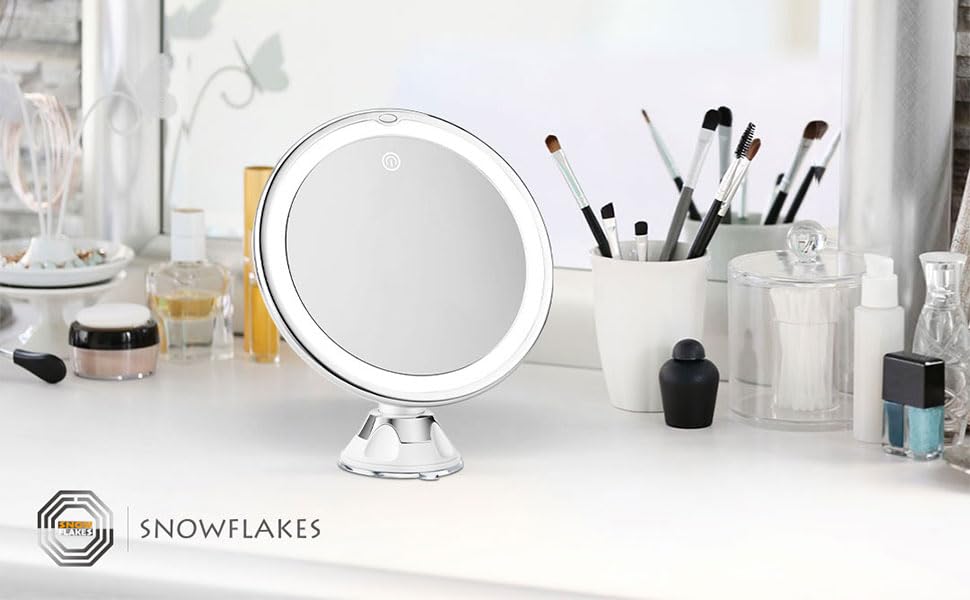 Snowflakes mirror held in hand to show compact scale and travel convenience