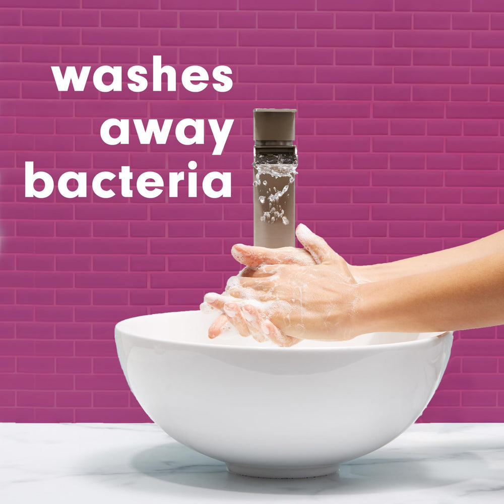 Softsoap bottle held in hand showing 332 mL size for easy scale and refill benefit