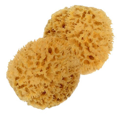 Spa Destinations sponges held in hand to show 3–4 inch size advantage