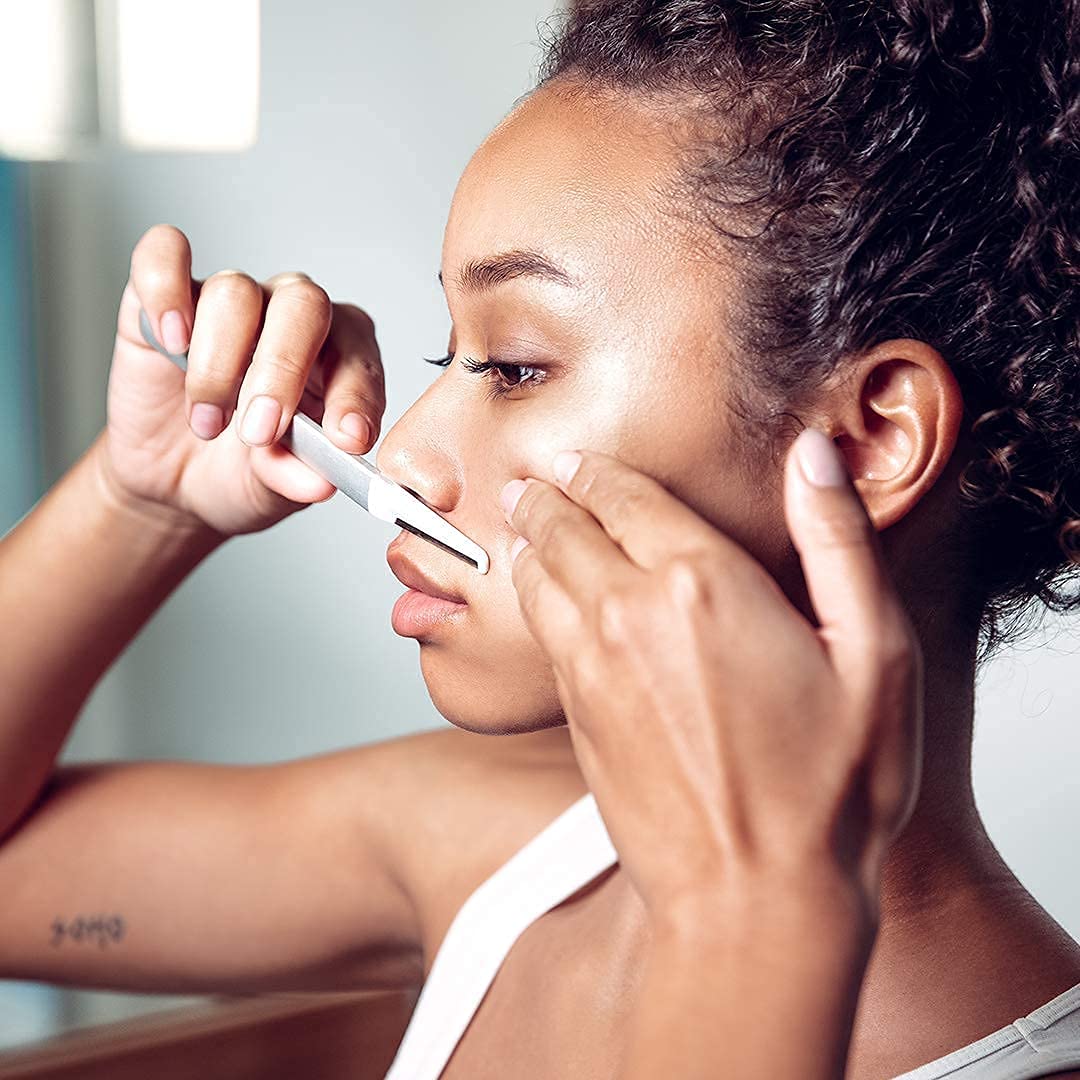 StackedSkincare blade in use on cheek showing gentle exfoliation benefit