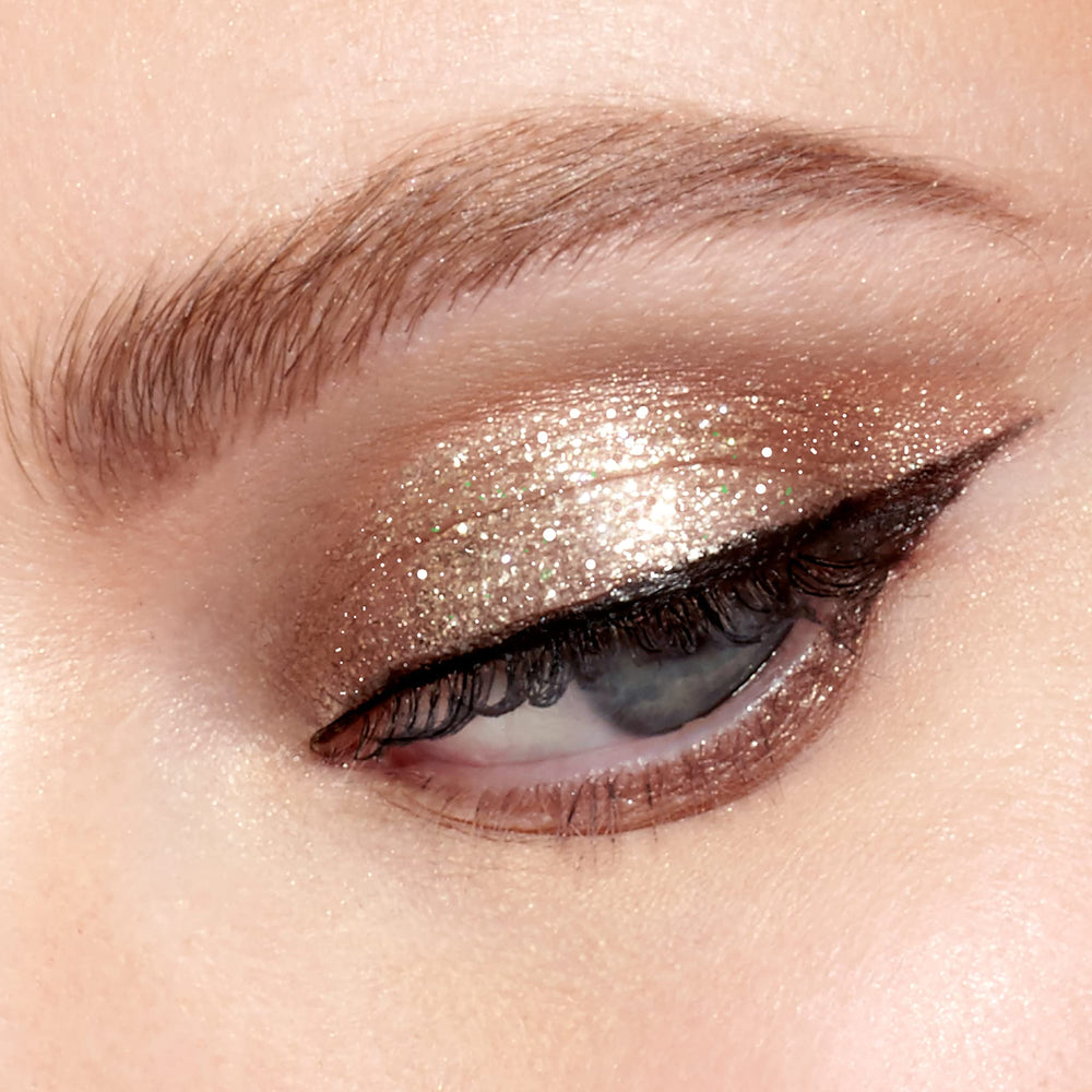 stila product swatched on eyelid demonstrating Kitten Karma brightening and minimal fallout