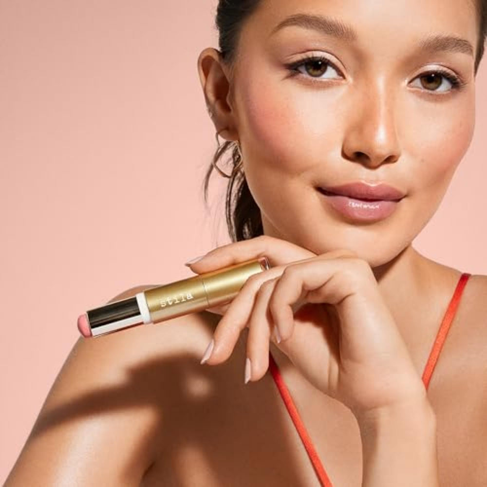 stila in handbag next to mirror for on-the-go touch-up ease