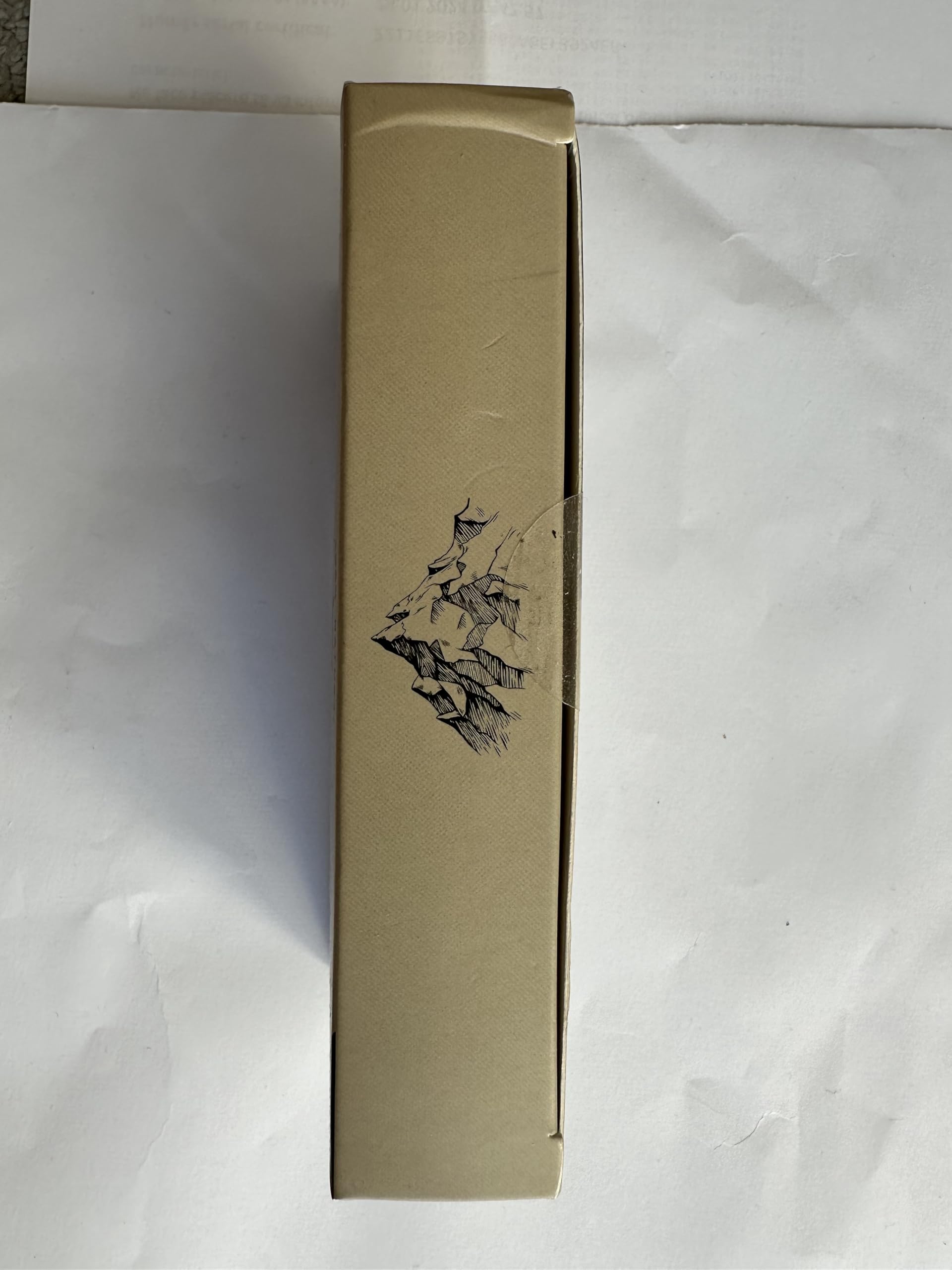 Striking Viking tin next to coin showing compact 2 oz size benefit