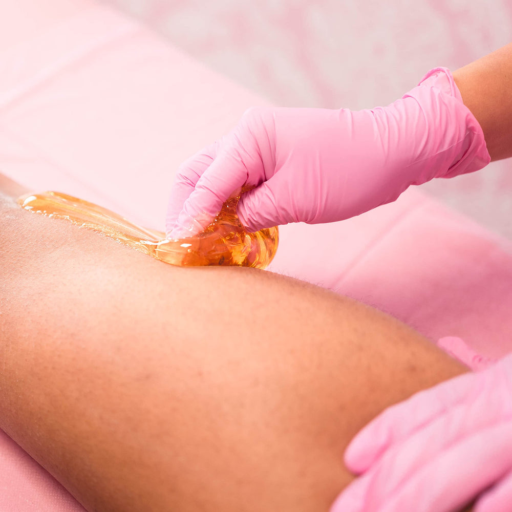 Applying Sugaring NYC paste with spatula on bikini area for precise hair removal
