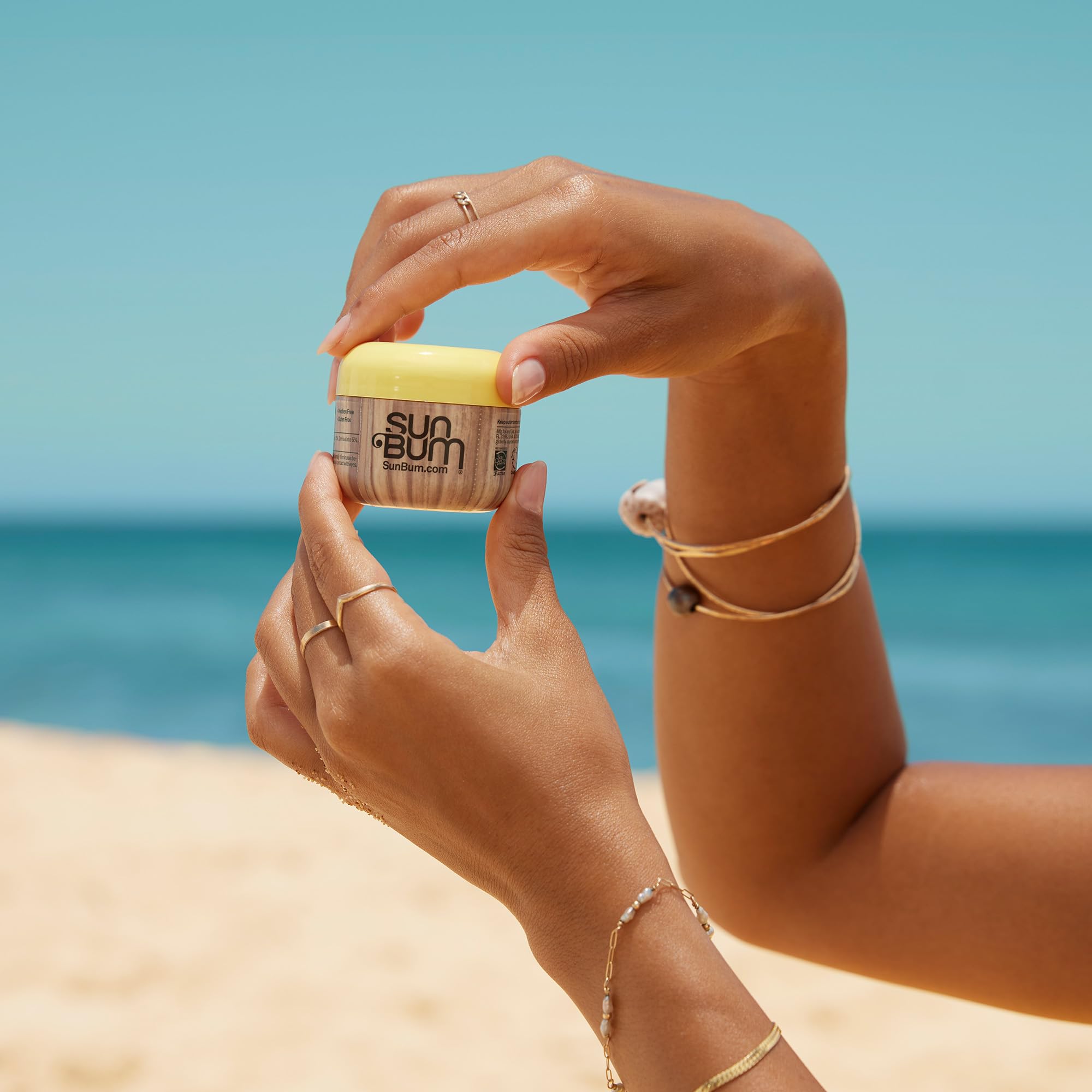 Sun Bum being applied to face from tube, non-greasy hydration benefit