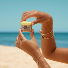 Sun Bum being applied to face from tube, non-greasy hydration benefit
