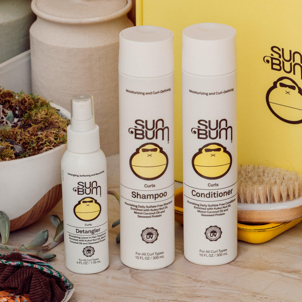 Sun Bum 4 oz detangler beside everyday items for size comparison