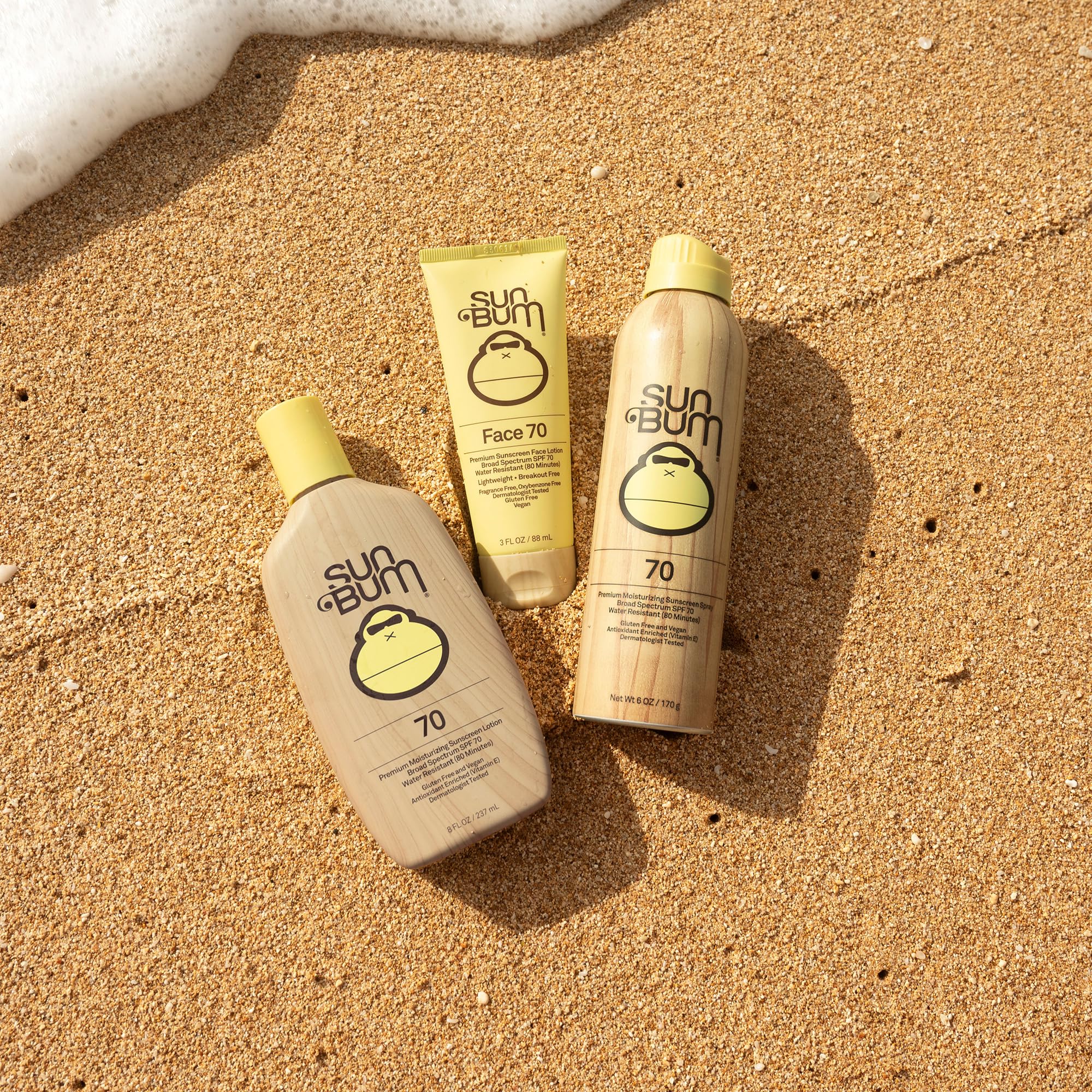 Sun Bum spray being applied at beach for active outdoor protection benefit
