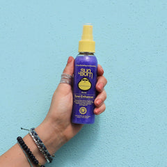 Label and texture detail of Sun Bum 4 oz bottle showing clear ingredient and travel benefit