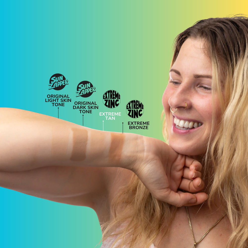 Tan swatch of Sun Zapper on arm showing natural finish and visible coverage benefit