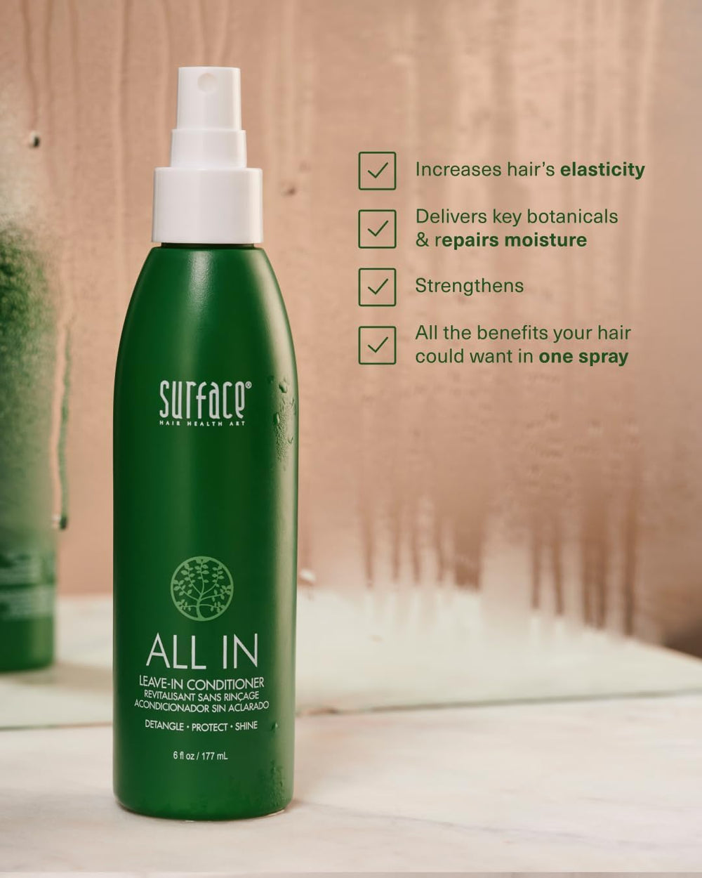 Hand holding Surface 6 oz bottle to show compact travel-friendly size and convenience