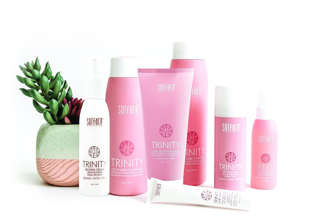 Surface Trinity conditioner being rinsed in shower demonstrating detangle benefit