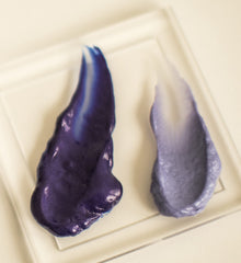 Hand holding Surface 7 oz bottle to show size and travel-friendly scale
