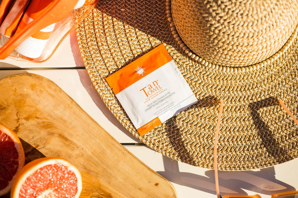Tan Towel pack on bathroom vanity suggesting convenient travel-ready tanning
