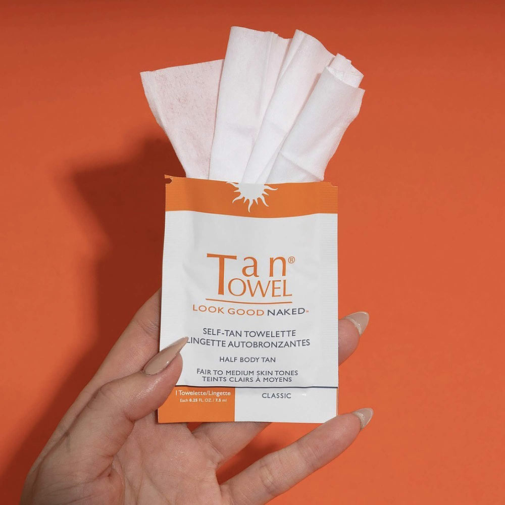 Tan Towel towelette held next to hand to show Classic size and easy portability
