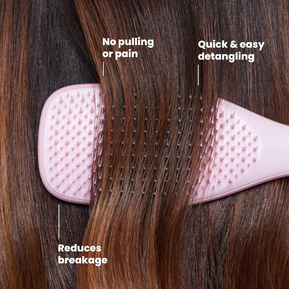 TANGLE TEEZER held in hand to show size and portability for travel convenience