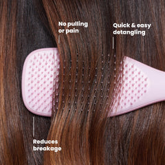TANGLE TEEZER held in hand to show size and portability for travel convenience