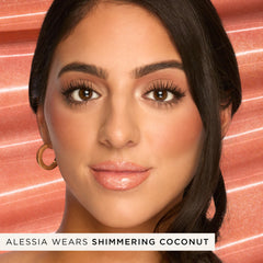 tarte texture swipe on arm showing glossy finish and sheer shimmering coconut tint