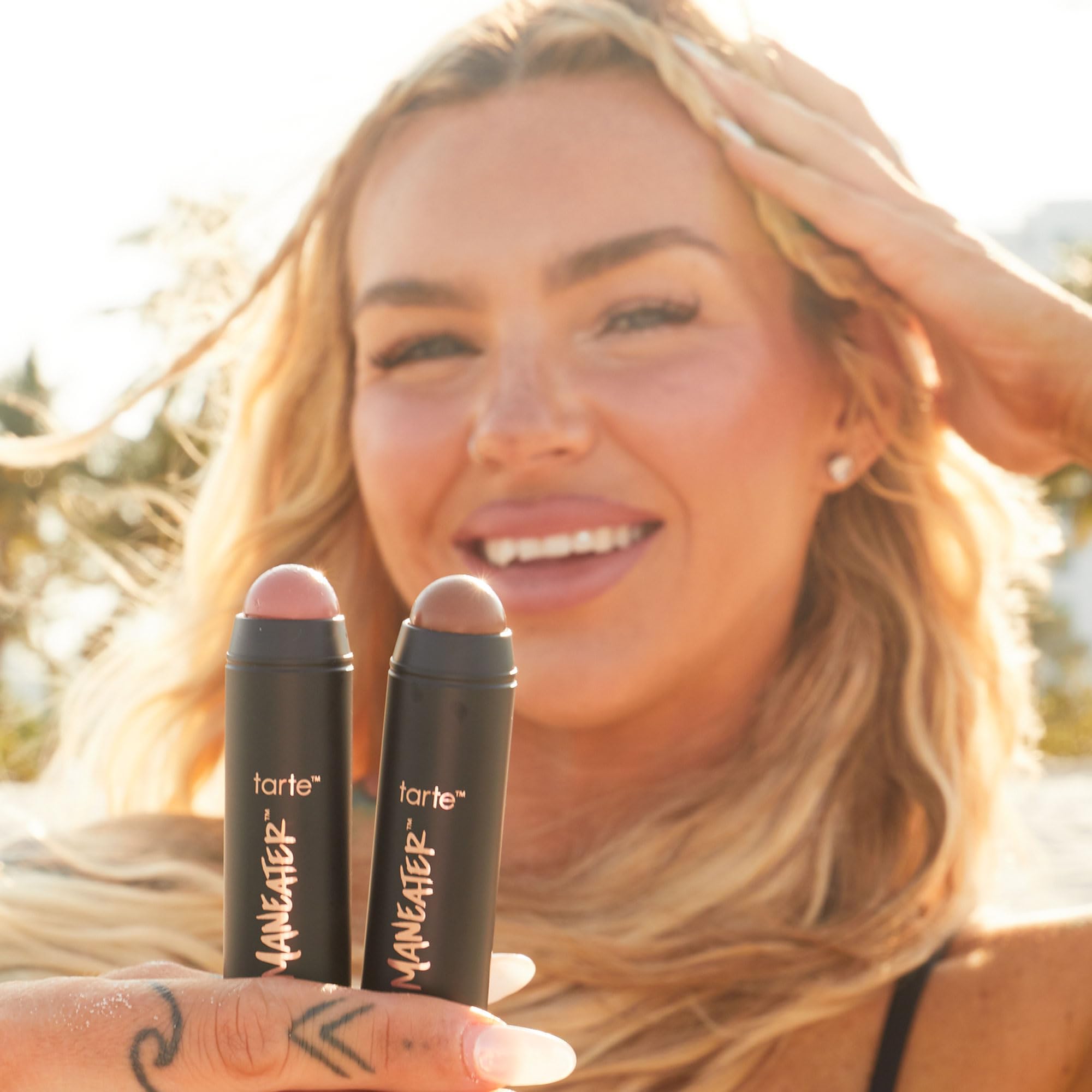 tarte applying stick bronzer in hand demonstrating quick on-the-go sculpting benefit