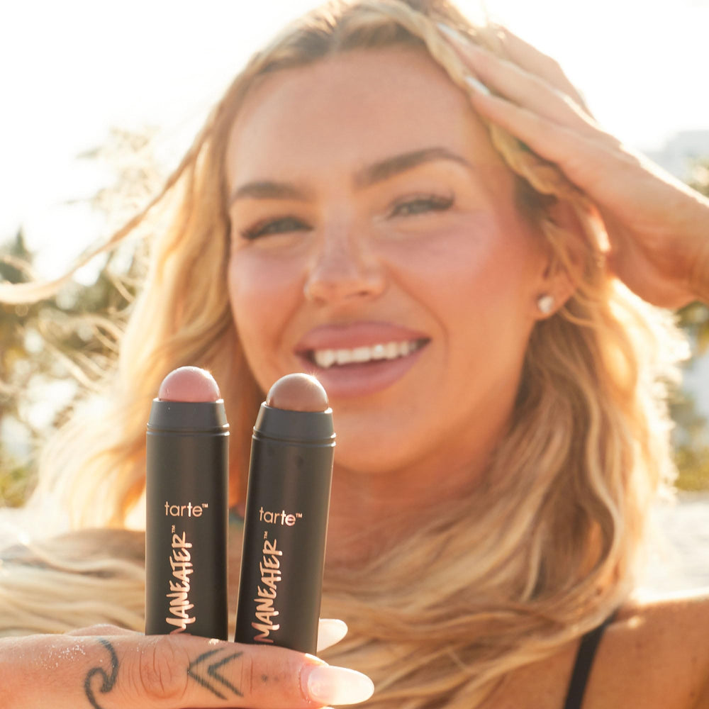tarte applying stick bronzer in hand demonstrating quick on-the-go sculpting benefit