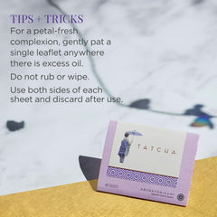 TATCHA packet beside a coin and hand to show compact scale for purse portability
