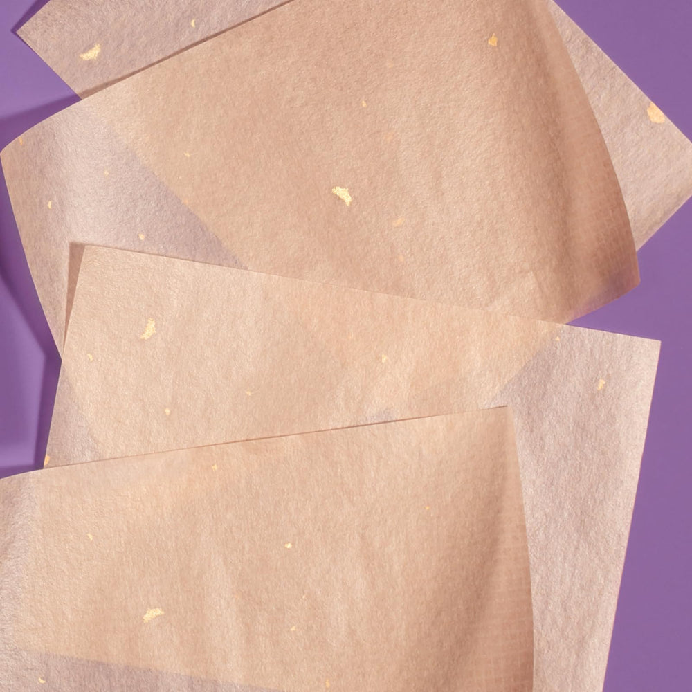 TATCHA sheets staged on vanity with skincare items, showcasing effortless touch-up convenience